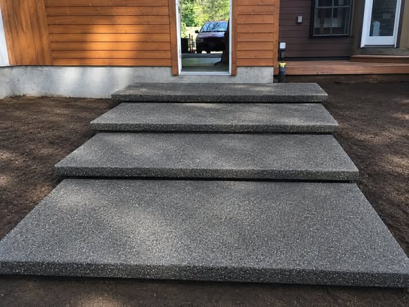 Exposed-aggregate concrete steps at a residential entry