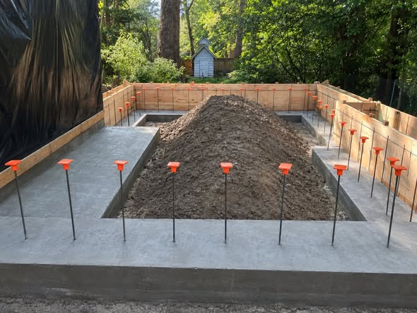Poured foundation with anchor bolts and rebar ready for framing
